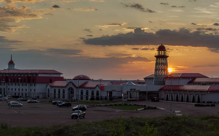 Casino New Brunswick in Moncton at sunset: the hotel block, red-roofed casino wings and lighthouse-style tower beyond the parking lot